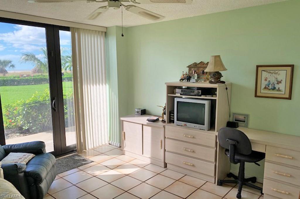 180 Seaview Court, Unit 111 Marco Island, FL 34145 - Photo 13 of 24 a bedroom with furniture and a window