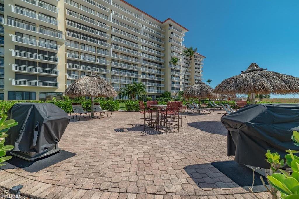 180 Seaview Court, Unit 111 Marco Island, FL 34145 - Photo 17 of 24 a view of a patio with a table and chairs