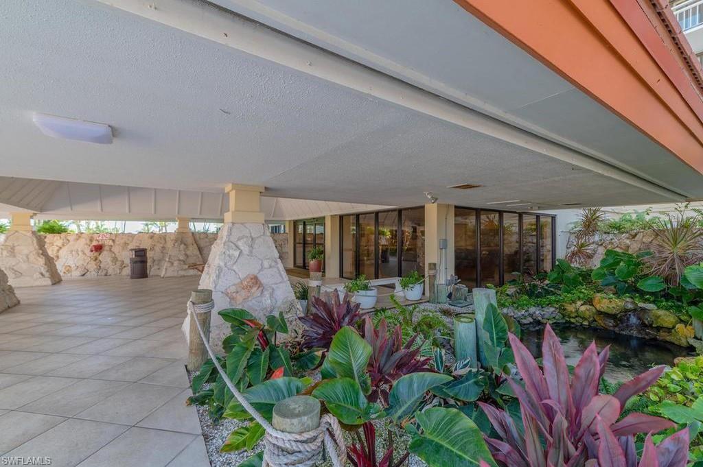 180 Seaview Court, Unit 111 Marco Island, FL 34145 - Photo 3 of 24 a front view of a house with garden