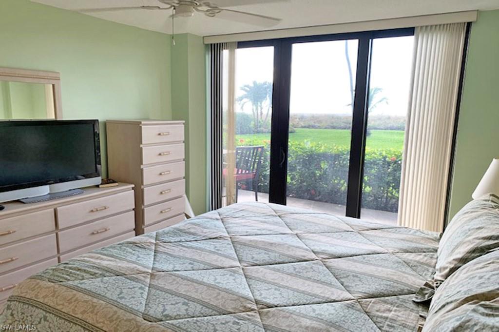 180 Seaview Court, Unit 111 Marco Island, FL 34145 - Photo 10 of 24 a bedroom with a bed and a flat screen tv