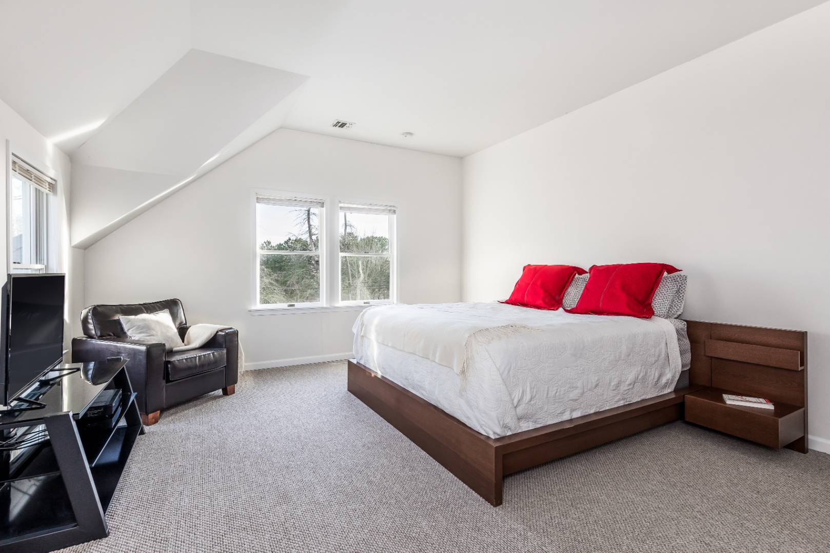 56 South Country Road Westhampton, NY 11977 - Photo 12 of 15 a spacious bedroom with a bed and a couch