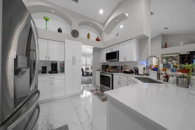 a kitchen with refrigerator and cabinets