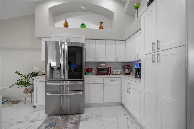 a kitchen with a white cabinets and white appliances