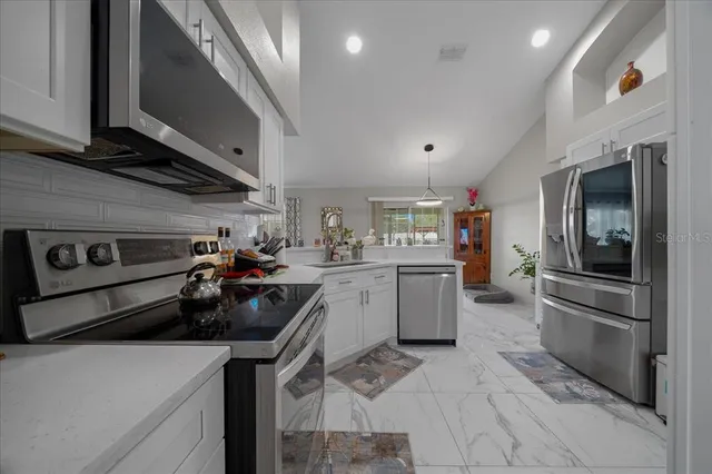 a kitchen with a sink stainless steel appliances and cabinets
