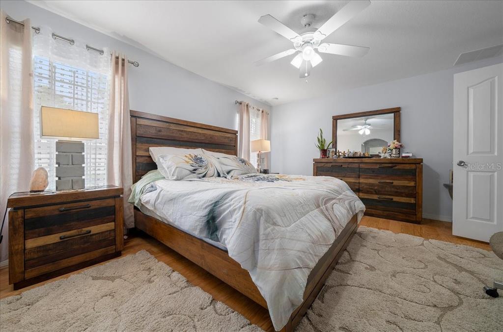4997 Southwest 107th Loop Ocala, FL 34476 - Photo 20 of 48 a bedroom with a bed and a dresser