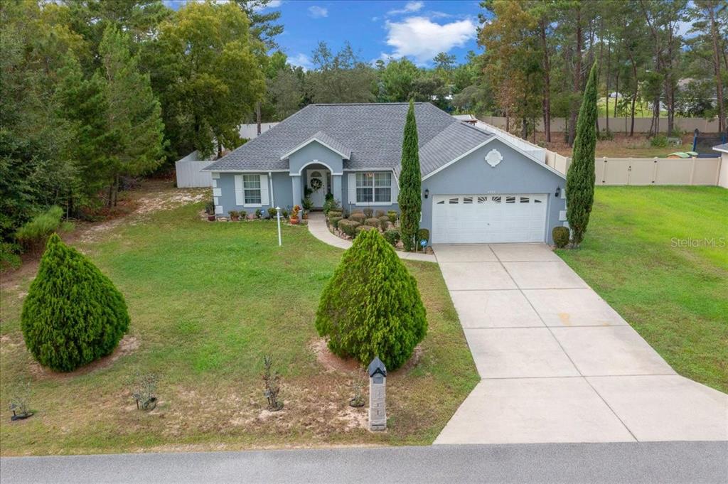 4997 Southwest 107th Loop Ocala, FL 34476 - Photo 2 of 48 a view of house with garden