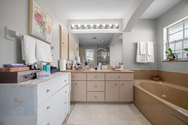 a bathroom with a bathtub and a sink