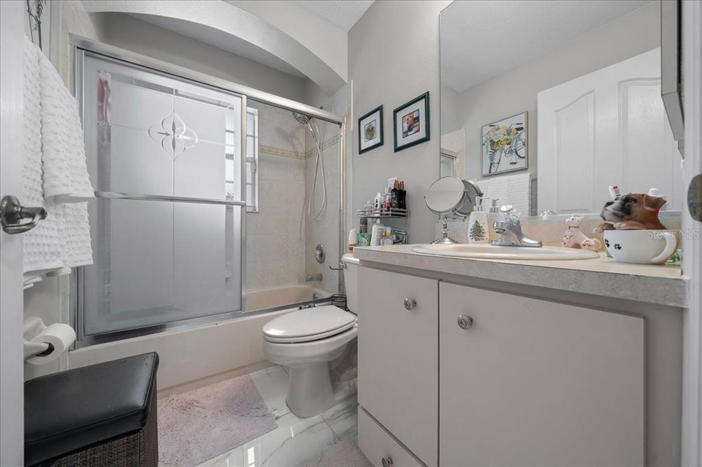 4997 Southwest 107th Loop Ocala, FL 34476 - Photo 29 of 48 a bathroom with a sink toilet and shower