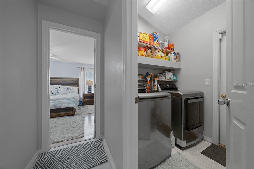 4997 Southwest 107th Loop Ocala, FL 34476 - Photo 33 of 48 a kitchen with a refrigerator and a sink