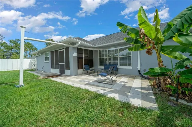 a view of house with backyard and porch