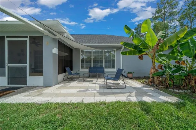 a building outdoor space with patio furniture and potted plants