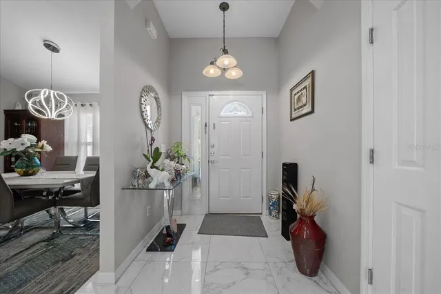a very nice looking room with a dining table a chandelier