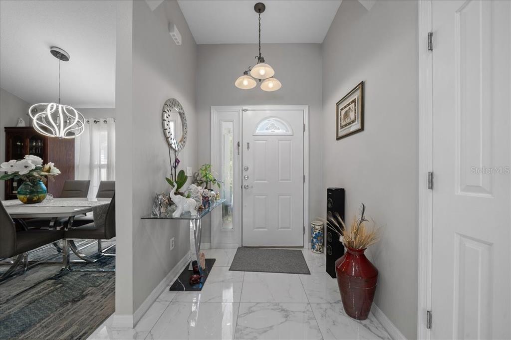 4997 Southwest 107th Loop Ocala, FL 34476 - Photo 4 of 48 a very nice looking room with a dining table a chandelier