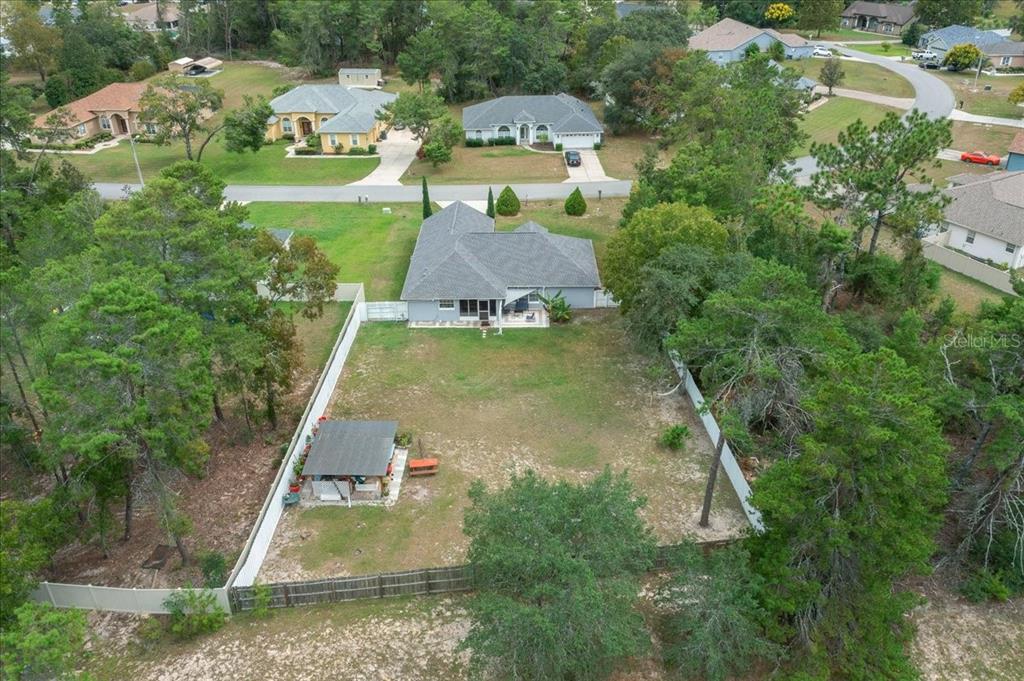 4997 Southwest 107th Loop Ocala, FL 34476 - Photo 45 of 48 an aerial view of a house with yard swimming pool and outdoor seating