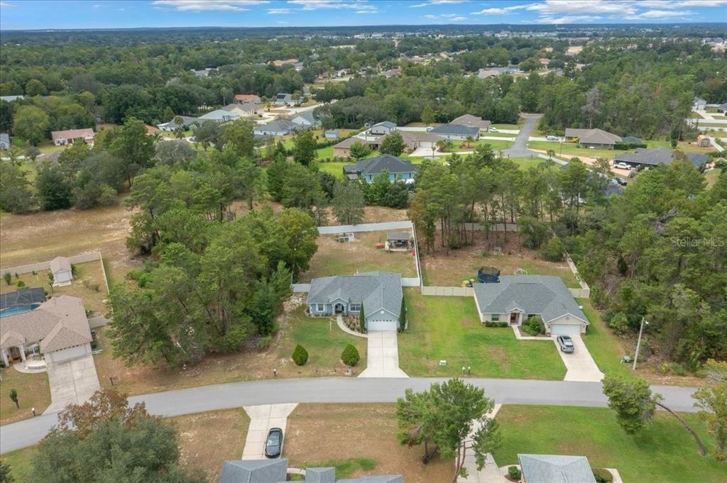 4997 Southwest 107th Loop Ocala, FL 34476 - Photo 46 of 48 an aerial view of residential houses with outdoor space and trees