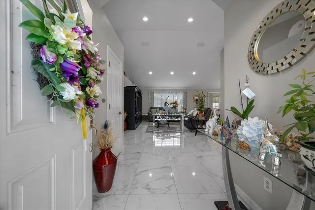 a view of living room filled with furniture and a chandelier