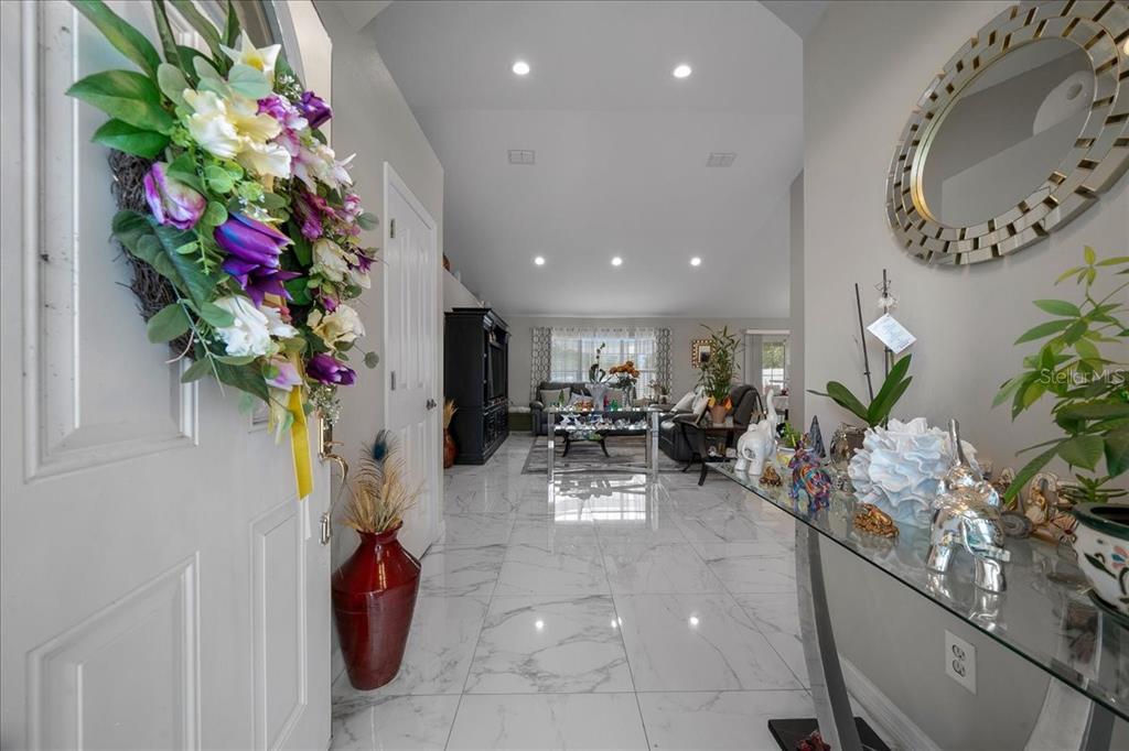 4997 Southwest 107th Loop Ocala, FL 34476 - Photo 5 of 48 a view of living room filled with furniture and a chandelier