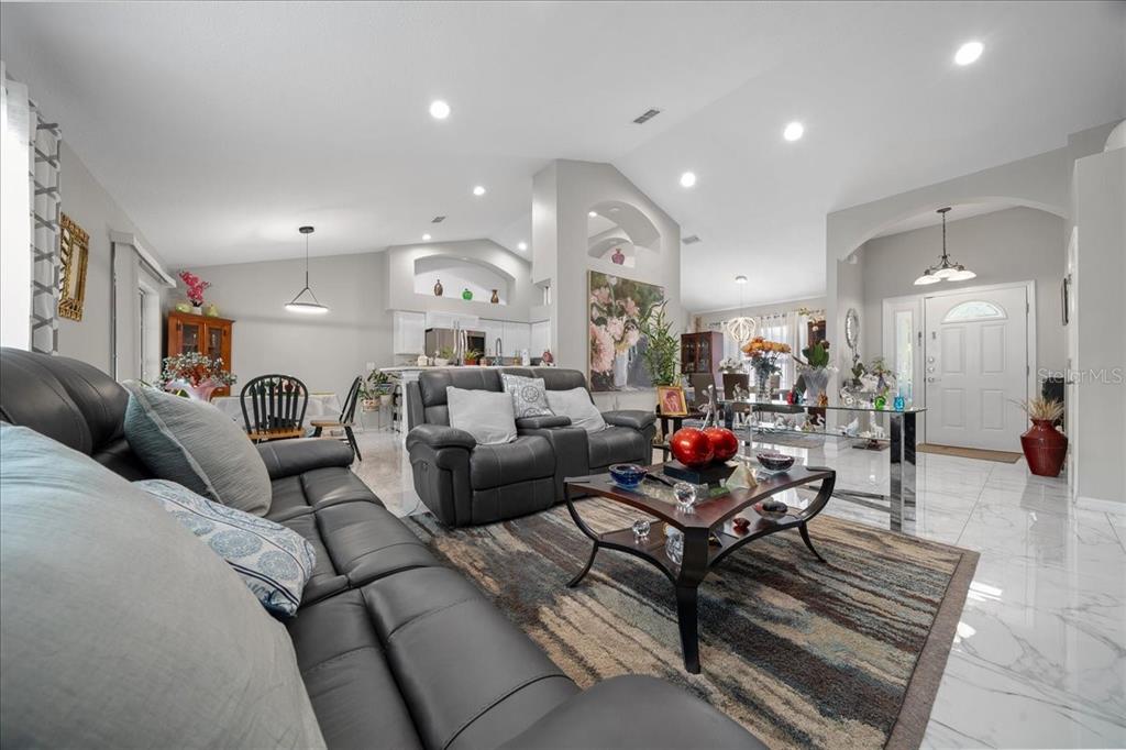 4997 Southwest 107th Loop Ocala, FL 34476 - Photo 7 of 48 a living room with furniture and a wooden floor