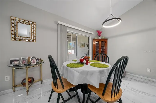 a dining room with furniture and window