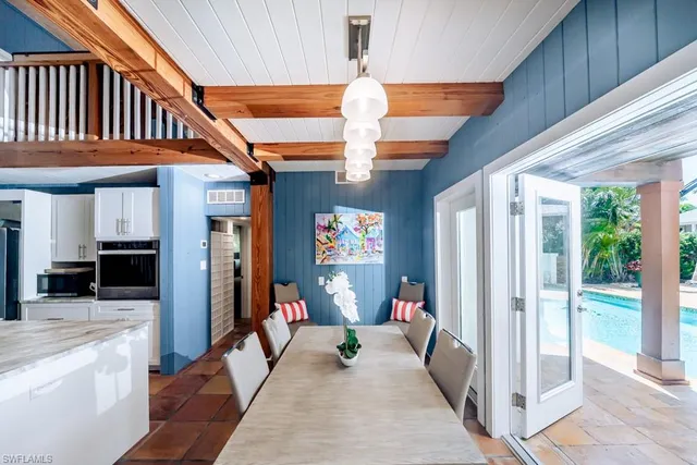 a dining hall with stainless steel appliances granite countertop a stove and cabinets