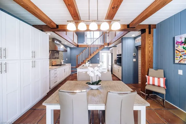 a bedroom with a bed and a flat tv screen on dresser