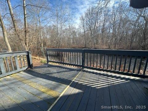 230 Main Street, Unit 63 Wallingford, CT 06492 - Photo 12 of 12 a view of deck with wooden floor and fence