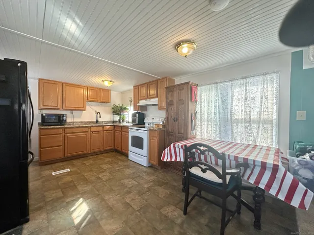 a kitchen with cabinets and wooden floor