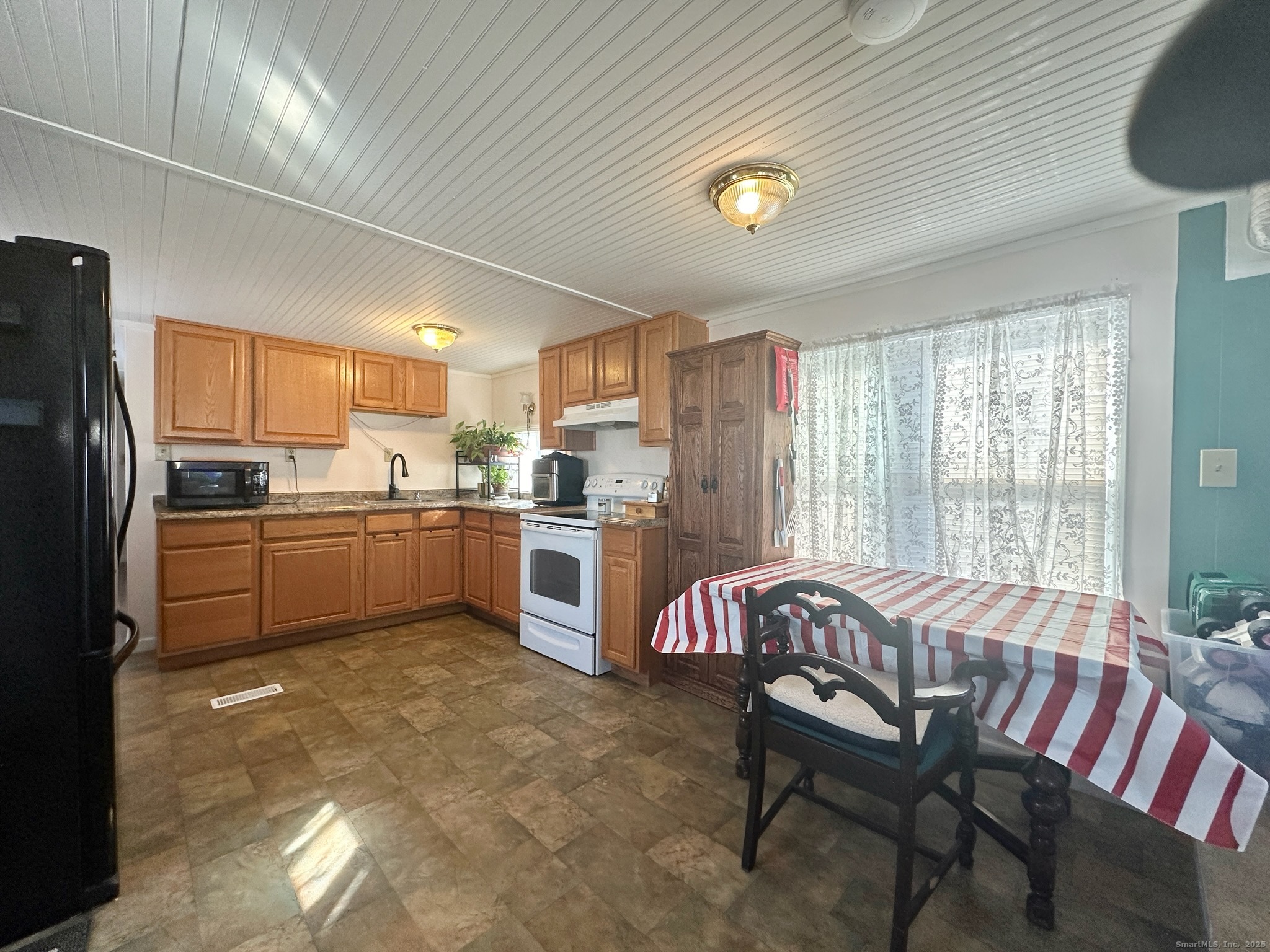 230 Main Street, Unit 63 Wallingford, CT 06492 - Photo 6 of 12 a kitchen with cabinets and wooden floor