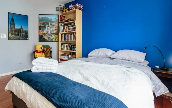 a bedroom with a bed and dresser