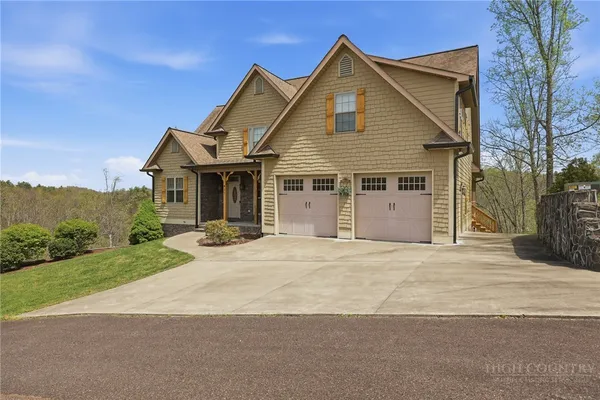 a front view of a house with a garden and yard