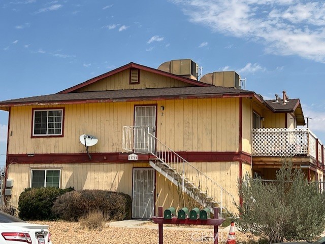 15754 Tern Road Victorville, CA 92394 - Photo 3 of 5 a front view of a house with a garden