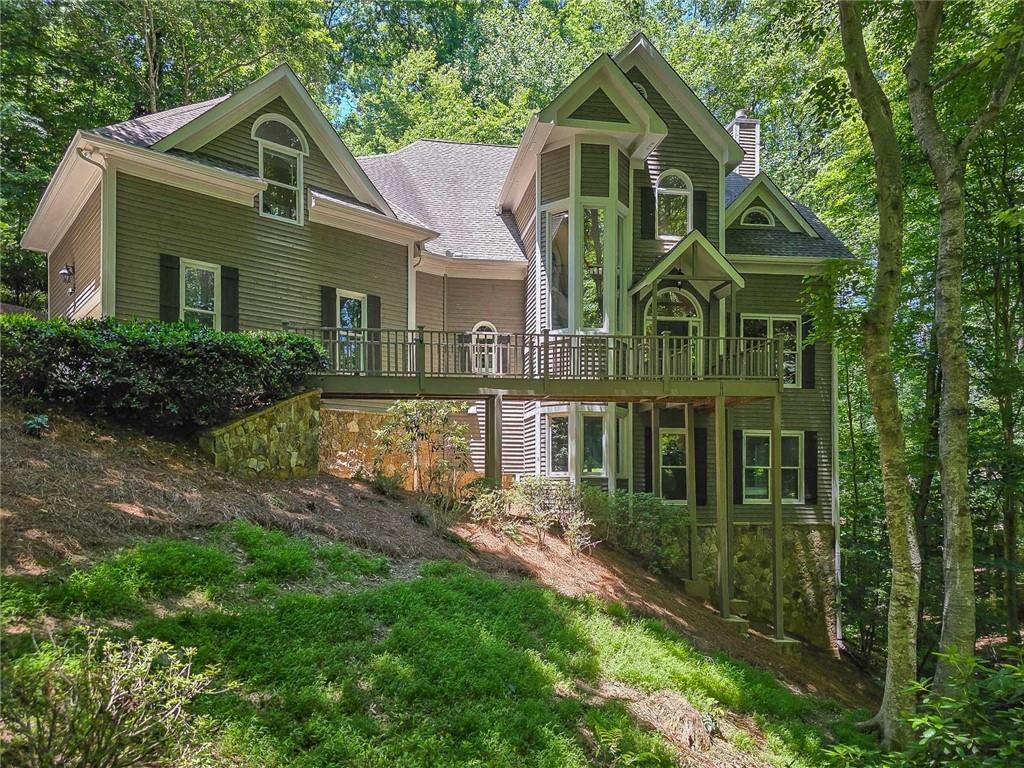 3712 Frederica Road Northwest Berkeley Lake, GA 30096 - Photo 2 of 49 a front view of a house with garden