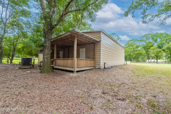 a small house with a trees in the background