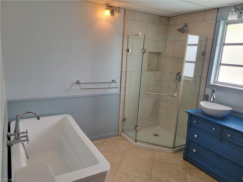2662 Mangrove Street Naples, FL 34112 - Photo 11 of 31 a bathroom with a shower sink and mirror