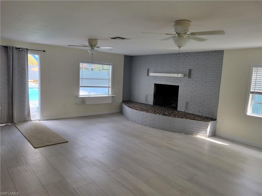 2662 Mangrove Street Naples, FL 34112 - Photo 12 of 31 an empty room with windows and fireplace