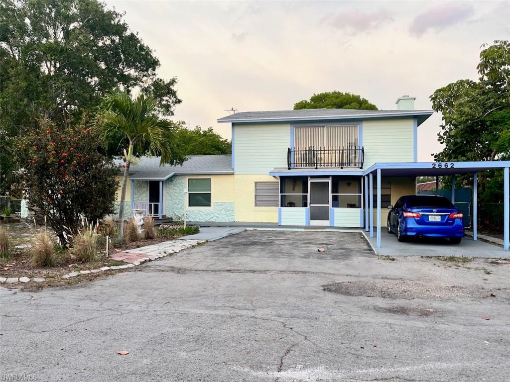2662 Mangrove Street Naples, FL 34112 - Photo 2 of 31 a view of a house with a patio and a yard