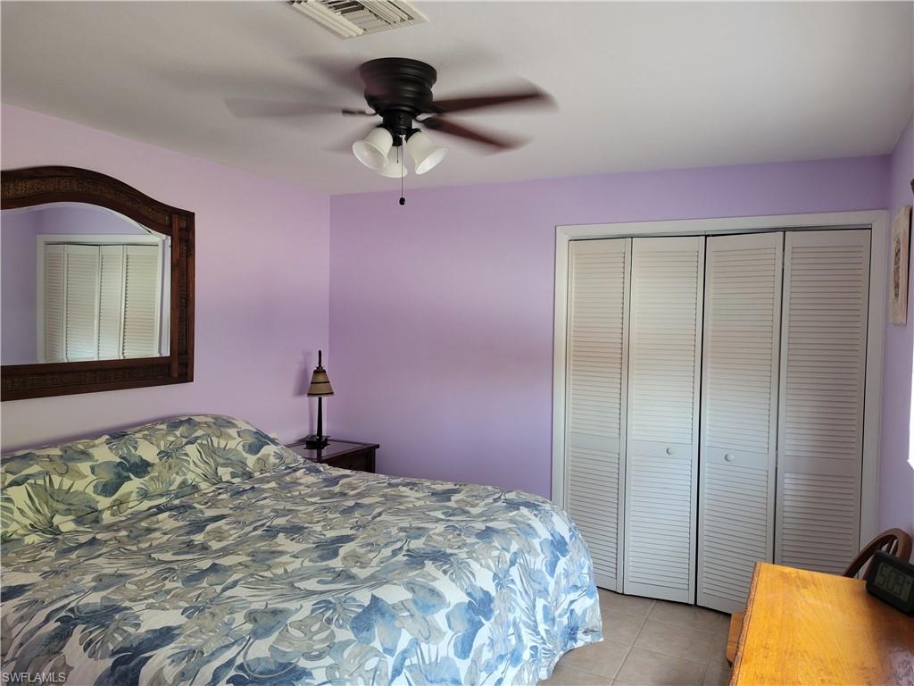 2662 Mangrove Street Naples, FL 34112 - Photo 21 of 31 a bedroom with a bed and a dresser