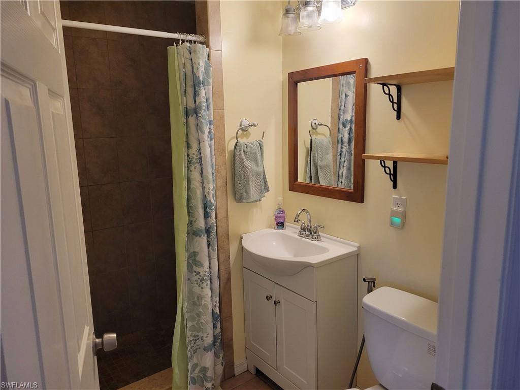 2662 Mangrove Street Naples, FL 34112 - Photo 22 of 31 a bathroom with a sink toilet and shower