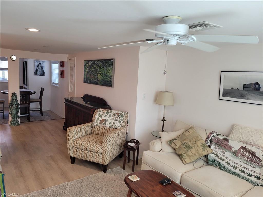 2662 Mangrove Street Naples, FL 34112 - Photo 25 of 31 a living room with furniture and a chandelier
