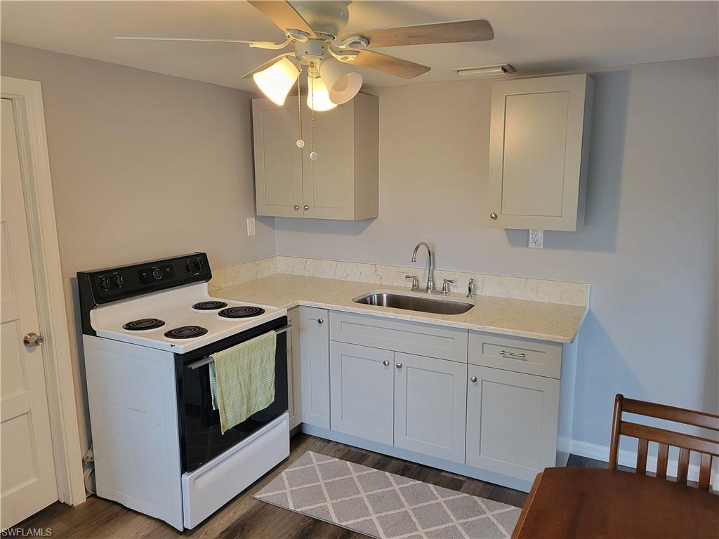 2662 Mangrove Street Naples, FL 34112 - Photo 27 of 31 a kitchen with stainless steel appliances a stove a sink and a refrigerator