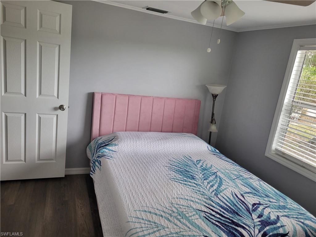 2662 Mangrove Street Naples, FL 34112 - Photo 28 of 31 a bed sitting in a bedroom next to a window