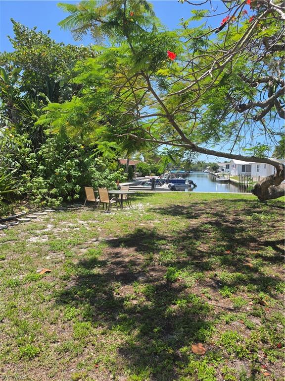2662 Mangrove Street Naples, FL 34112 - Photo 3 of 31 a view of yard with swimming pool and green space