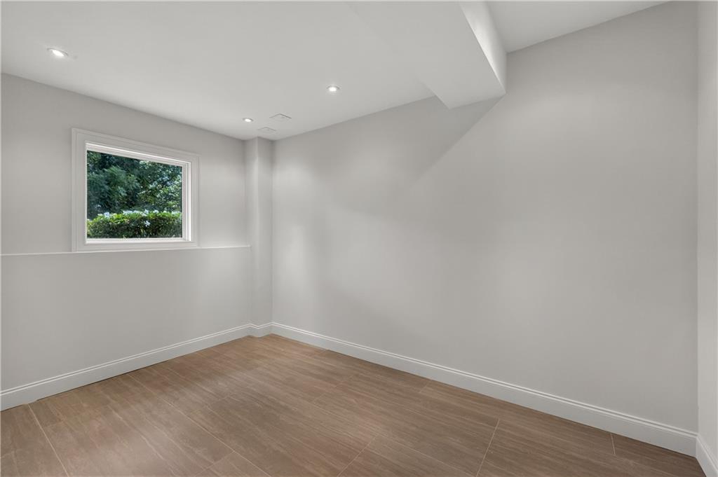 4610 West Morton Road Alpharetta, GA 30022 - Photo 44 of 53 a view of empty room with wooden floor and fan
