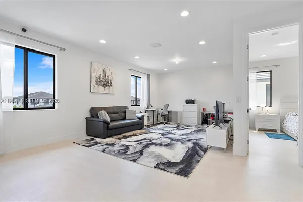 a living room with furniture and a large window