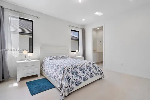 a bedroom with a large bed and a window