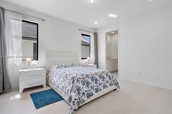 a bedroom with a large bed and a window