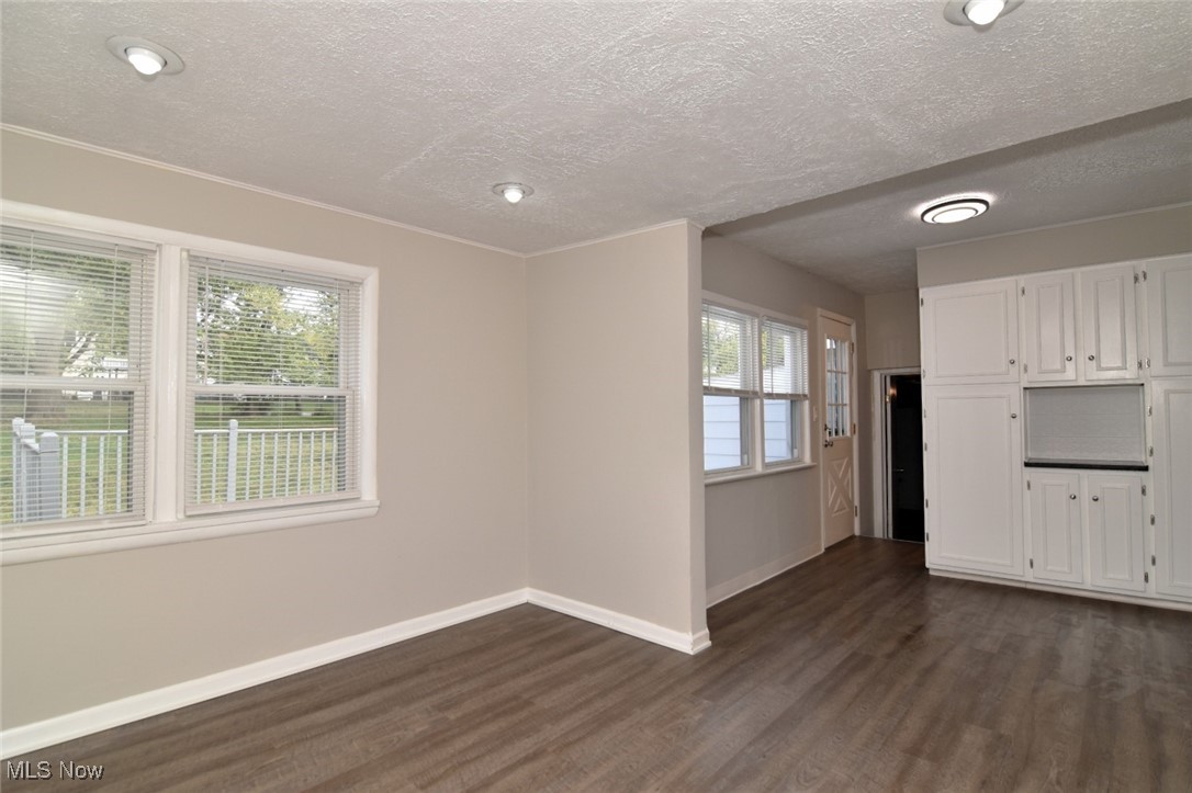 1443 Churchill Road Lyndhurst, OH 44124 - Photo 13 of 39 Unfurnished living room with dark wood-style floors and a textured ceiling