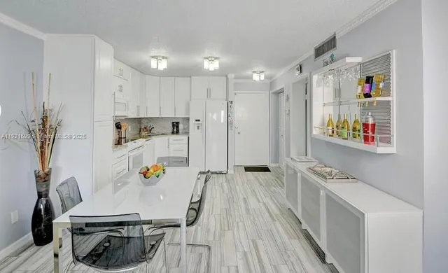 a kitchen with stainless steel appliances a stove a sink and a refrigerator