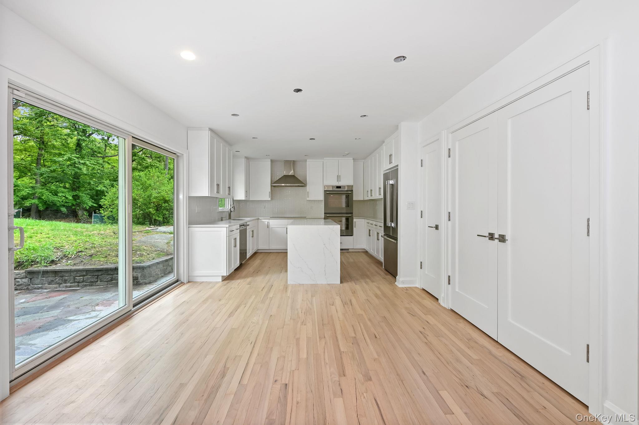 24 Country Road Mamaroneck, NY 10543 - Photo 9 of 37 a view of a kitchen with wooden floor and electronic appliances
