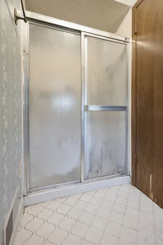 a bathroom with a glass shower door